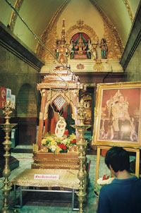 Urn with Holy Water next to King Bhumibol's portrait.
