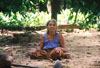 village lady sitting net to hoe