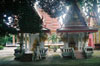 a photograph of two shrines with two monks who helped re-build Wat Mongkonsathit.