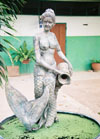 a photograph of a mermaid with a water pitcher.